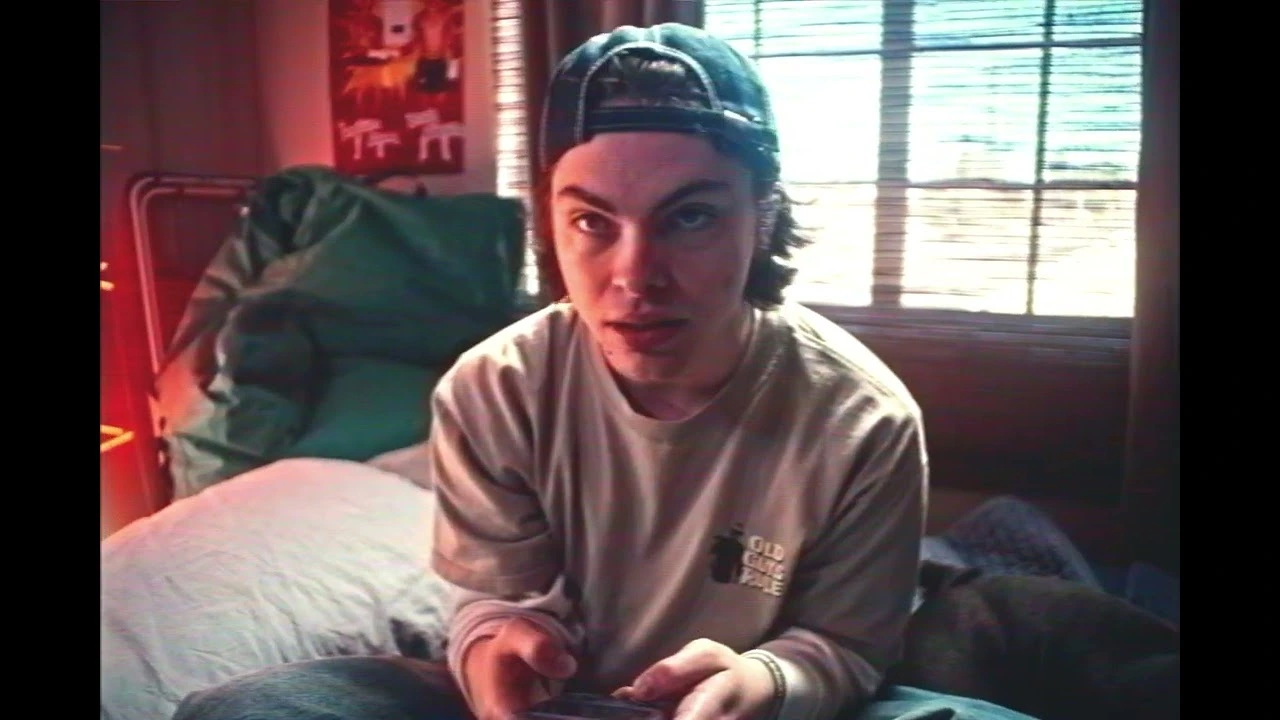 Chase Keith holding a controller in a bedroom