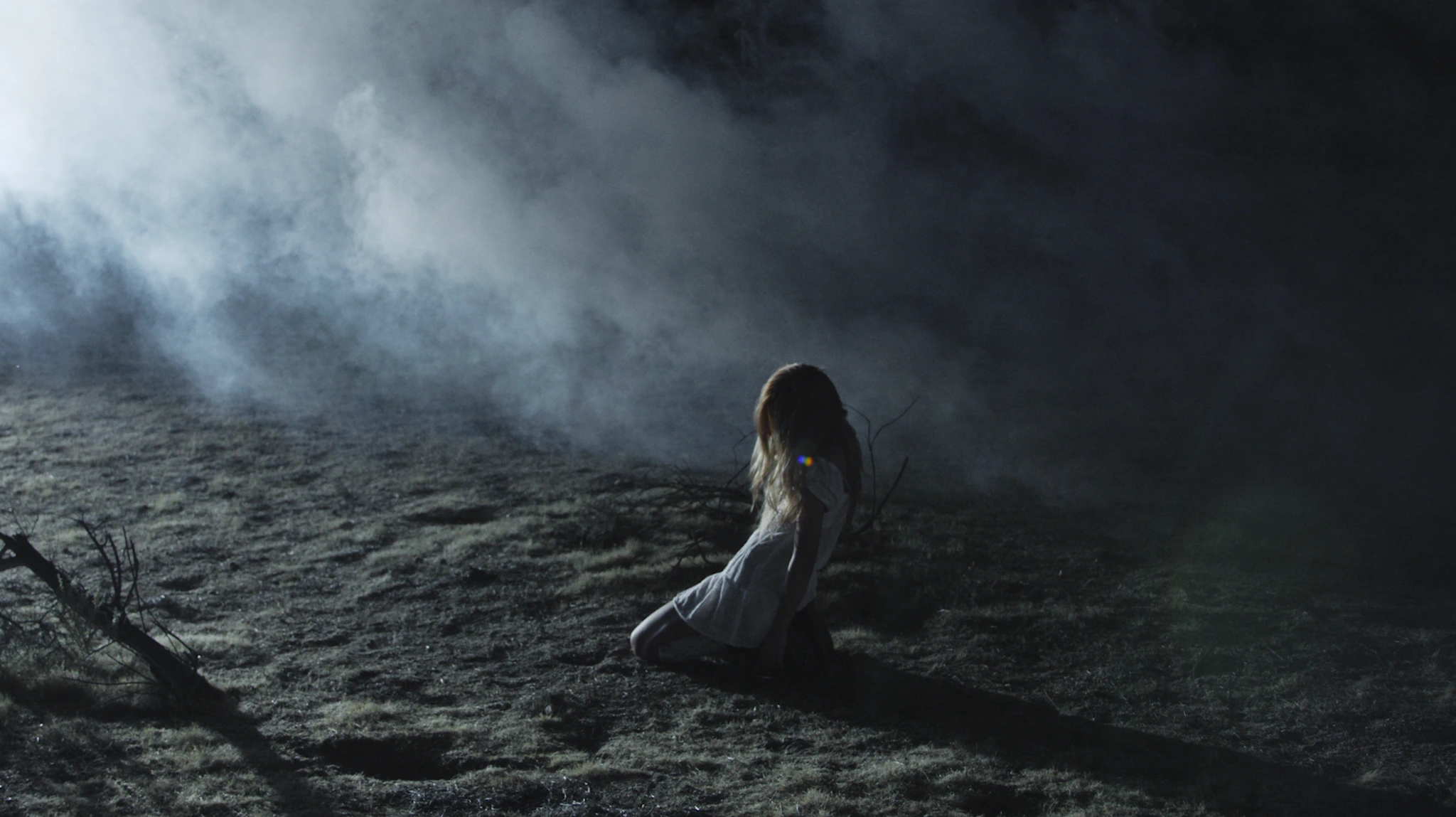 A figure kneeling in a smoke-filled desert in MEANT TO BE
